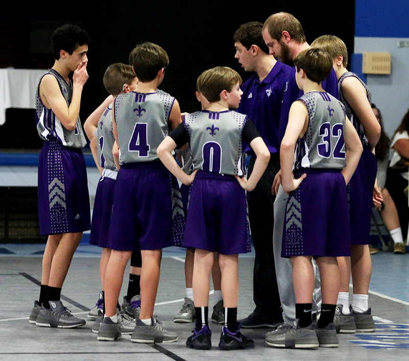 Coach matt at a time out with JV basketball team