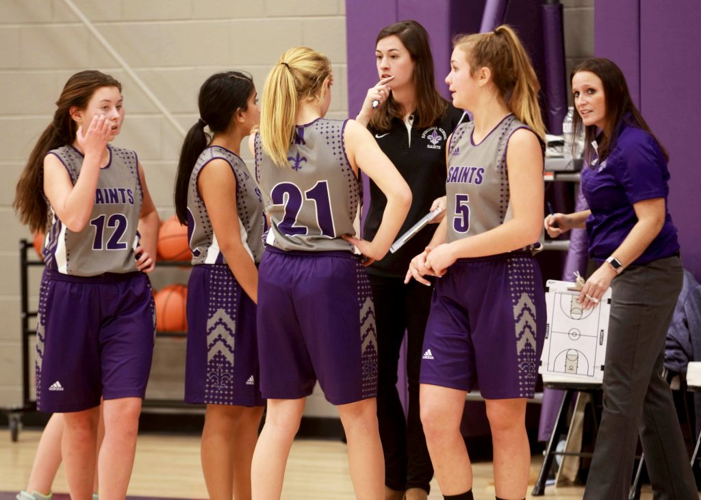 sara huff keeps stats on the basketball court